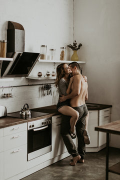  beautiful loving couple kissing in the kitchen