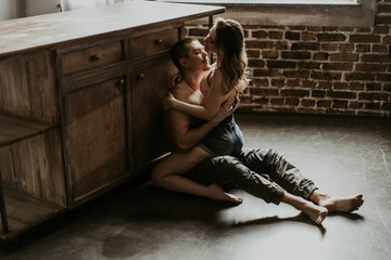  beautiful loving couple kissing in the kitchen