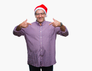 Handsome senior man wearing christmas hat over isolated background looking confident with smile on...