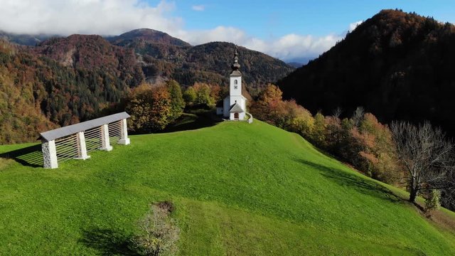 Lonely church on hilltop in picturesque rural Slovenia, 4K aerial drone footage.