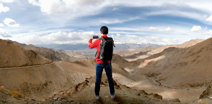 Man take photo on the peak with beauty landscape background.