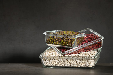 White beans, red beans mung bean in glass bowls on a dark background. Eco friendly, plastic free items.