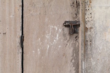Metal old rusty handle on wooden door