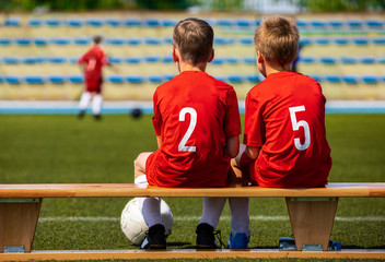 Kids Football Team. Two Young Boys Watching Soccer Match. Football Tournament Competition in the...