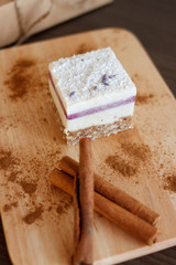 raw dessert cake with cinnamon on wooden board