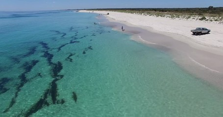 Low level flight from drone along sheltered beach towards paddler at Busselton Video 6