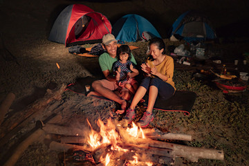 happy family at camping with campfire