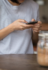 Hands of a woman using a mobile cell phone