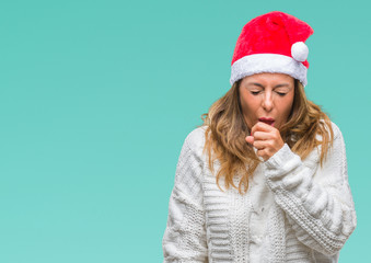 Middle age senior hispanic woman wearing christmas hat over isolated background feeling unwell and coughing as symptom for cold or bronchitis. Healthcare concept.