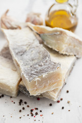 dry cod fish on white ceramic background