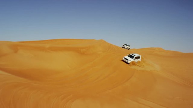 Aerial Dubai Drone view of Desert Safari vehicles dune bashing