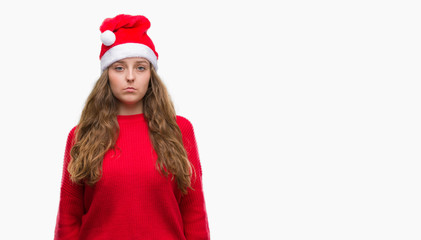 Young blonde woman wearing santa claus hat with a confident expression on smart face thinking serious