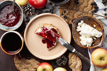 Swedish rye crispbread with cream cheese and raspberry jam. Autumn and winter breakfast concept.
