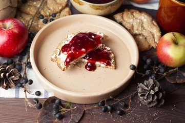 Swedish rye crispbread with cream cheese and raspberry jam. Autumn and winter breakfast concept.