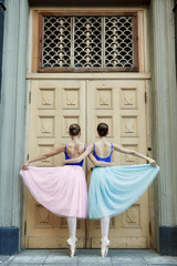 Ballet dancers dancing on street. Young ballerinas in color tutus. Ballet feet on the point