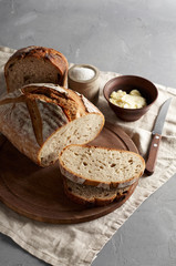 Artisan sliced toast bread with butter and sugar on wooden cutting board