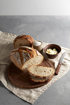 Artisan sliced toast bread with butter and sugar on wooden cutting board