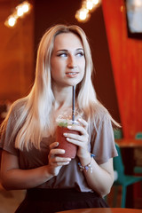 Beautiful Young Woman with Fruit smoothie