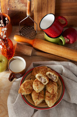 Russian meat piroshki. Traditional hand mini pies on wooden background