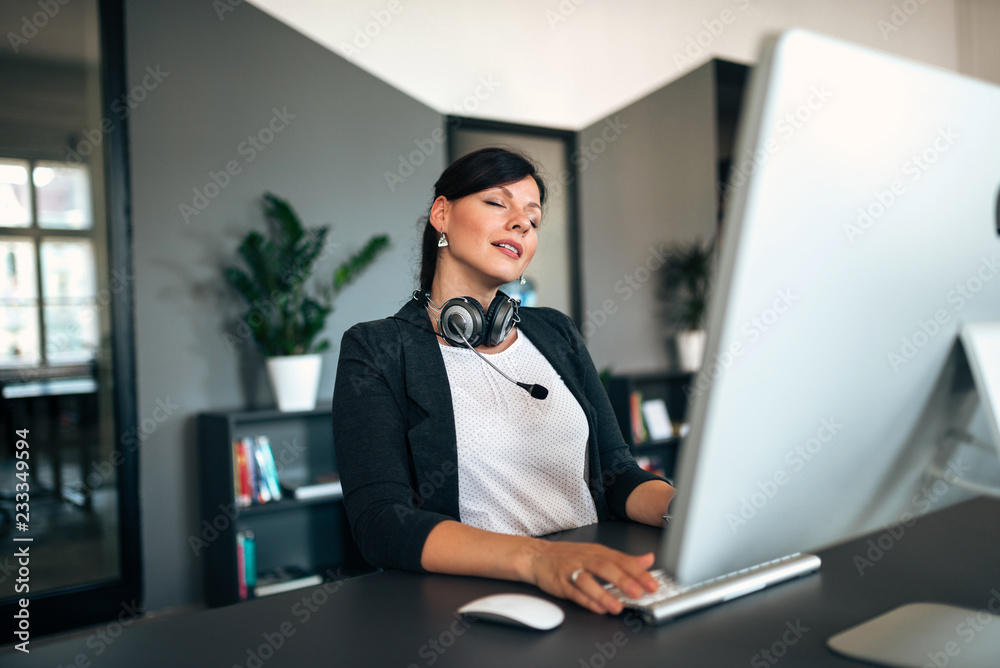 Poster taking a break. relaxed woman at office desk.