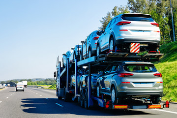 Cars carrier truck on asphalt road in Poland