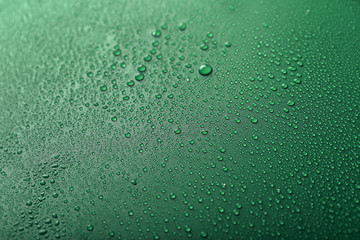 Drops of water on color background