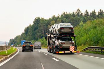 Fototapeta na wymiar Cars carrier truck in asphalt highway road in Poland