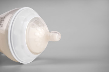 Closeup view of bottle of milk for baby on white background