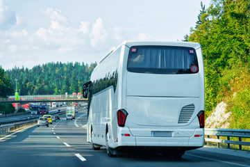 Fototapeta na wymiar White Tourist bus in road in Poland