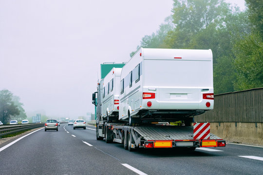 Truck carrier with motor homes rv on road of Slovenia