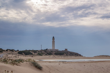 Fototapeta na wymiar Sandy beach at Trafalgar in spain overlooking the sea the waves and the lighthouse