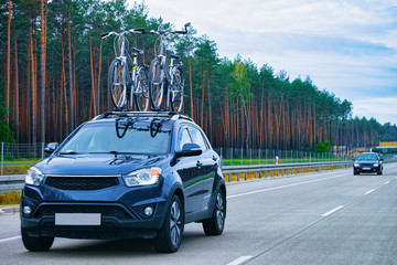 Car with bicycles on highway road in Poland concept