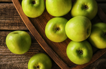 Ripe tasty apples on wooden board