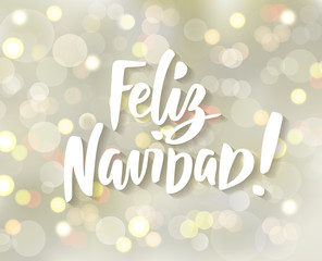 Feliz Navidad - spanish Merry Christmas hand drawn text. Holiday greetings quote. White and gold sparkling glowing lights. Background with bokeh effect.