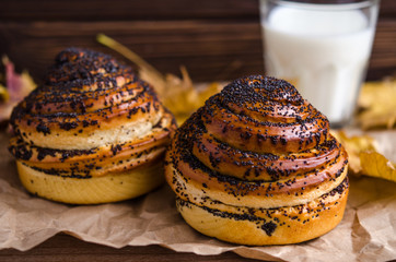 fresh bun with poppy seeds and a glass of milk