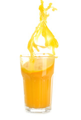 Glass of orange juice with splash on white background