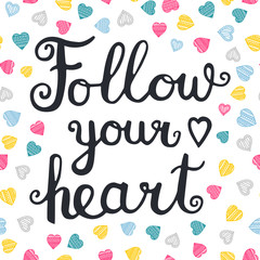 Follow your heart. Vector hand drawn lettering quote for cards, T shirts, labels, posters. Inspirational romantic quote. Isolated. On white background with color doodle hearts.