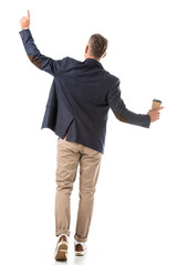 rear view of stylish man in jacket gesturing by hands and holding paper coffee cup isolated on white