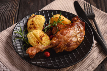 Roasted duck legs with apples and cranberries.