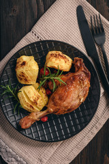 Roasted duck legs with apples and cranberries.