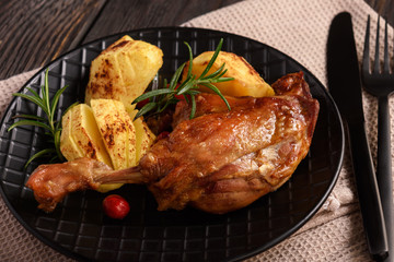 Roasted duck legs with apples and cranberries.