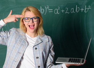 Educational reforms concept. Woman tired or annoyed holds laptop. Educator smart clever lady with...