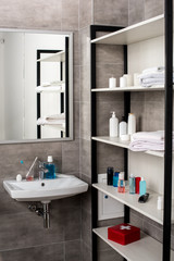 Fototapeta na wymiar interior of modern bathroom with sinks and shelves with beauty products
