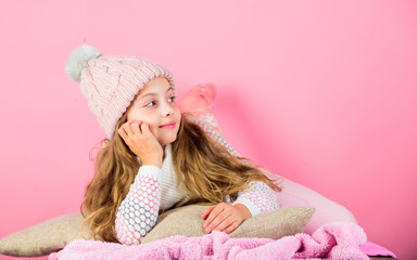 Kid girl knitted hat and scarf. Winter accessory concept. Girl long hair dream pink background. Kid dreamy wear knitted hat. Winter rest and relax. Winter season concept. Winter fashion accessory