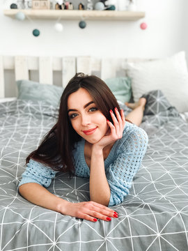 attractive brunette girl in lingerie lying on bed