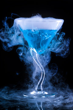 Blue Cocktail With Splash And Ice Vapor