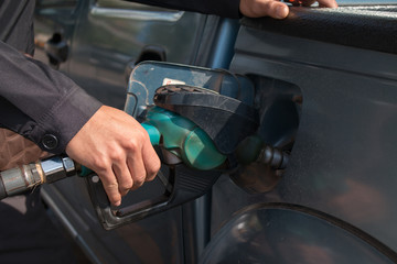 Hand Pumping Gas Into Car