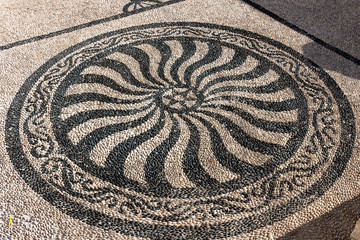 Traditional black and white pebbled mosaic for external paving of Agios Nicolao church - Chalki, Halki. Dodecanese Islands, Greece
