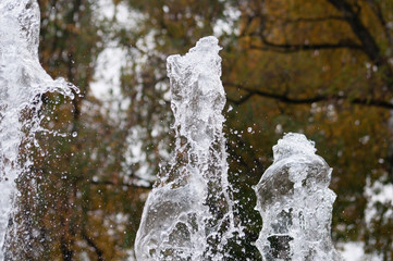 Many water streams, water splashes and drops in the fountain. Abstract background of water trickles...