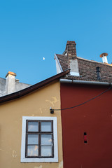 Fragment of old multicolored building with window in the city